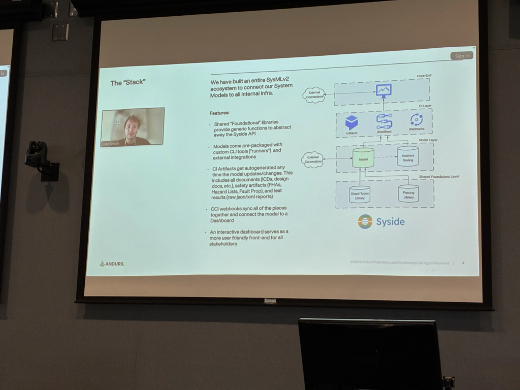 Cole Smith presenting Anduril's four-layer SysML v2 stack at System-as-Code Fest 2026-H1